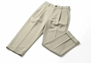 A pair of light-colored, pleated trousers with a cuffed hem, perfect for a classic golf outfit.