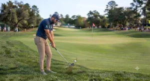 Executing a pitching wedge approach shot from the edge of the fairway