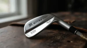 Detailed view of forged blade tour-issue golf irons showing precision milling and sleek muscle-back design.